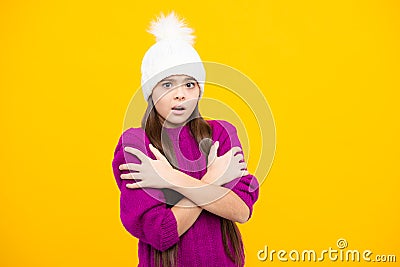 Modern teen girl wearing sweater and knitted hat on yellow background. Angry teenager girl, upset and unhappy Stock Photo