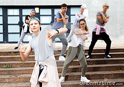 Modern teenager performing street dance with group Stock Photo