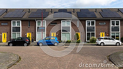 Modern Terraced houses with solar panels on the roof of rental houses. Photovoltaic panels on the roof. Stock Photo