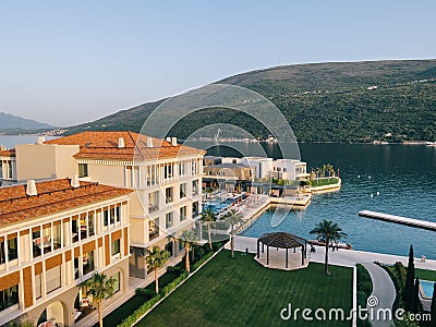 Modern three-story hotel with a private beach with a pool on the seafront overlooking the mountains Editorial Stock Photo