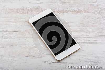 Modern touch screen smartphone on white wooden background Stock Photo