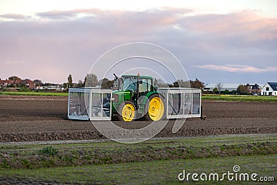 A tractor on farmland with a custom-built bulb planting machine in Voorhout Stock Photo