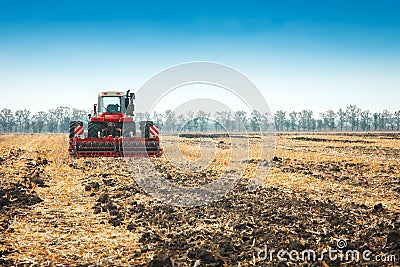 Modern tractor in the field with complex for the plowing. Stock Photo