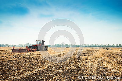 Modern tractor in the field with complex for the plowing. Stock Photo