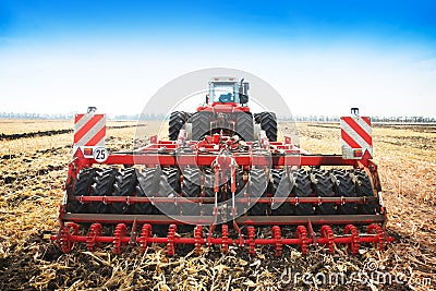 Modern tractor in the field with complex for the treatment and plowing of soil. Stock Photo