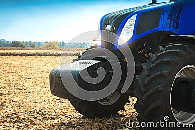 Modern tractor working in a field close-up. Stock Photo