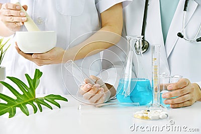 Modern and traditional medical, Alternative organic herbal drug and chemical medicine, Doctor mixing extraction for new pharmacy. Stock Photo