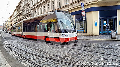 Modern tram in Prague. New public transport in Europe. Cobblestone street Editorial Stock Photo