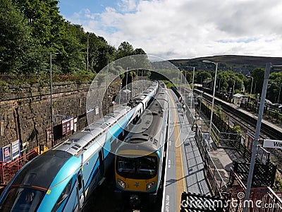 Modern transpennine train passing older train Editorial Stock Photo