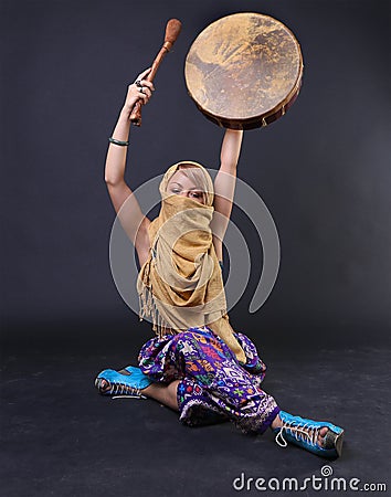 Modern Tribal Woman playing a drum Stock Photo