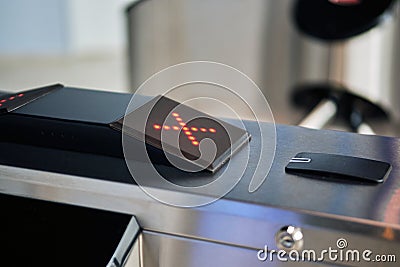 A modern turnstile shows a no passage sign in the form of a red cross Stock Photo