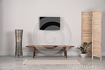 Modern TV set mounted on wall Stock Photo