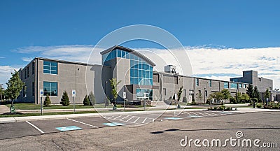 Modern Two-story Gray Building with Concave Entrance Stock Photo