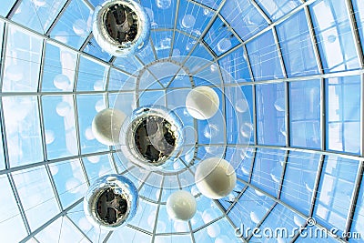 Modern urban abstract architecture glass ceiling in dome shape of a building with transparent roof floating balls imitating planet Stock Photo