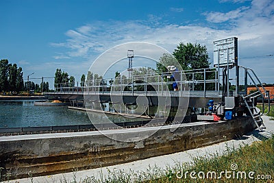 Modern urban sewage treatment plant. Dirty waste water flowing in sedimentation tank Stock Photo