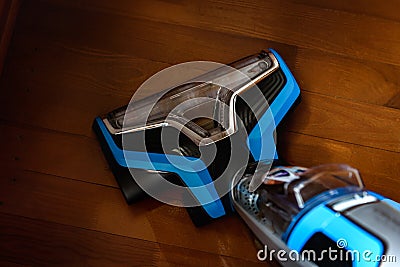 Modern vacuum cordless vacuum cleaner with water nozzle for cleaning floors. House cleaning. Stock Photo