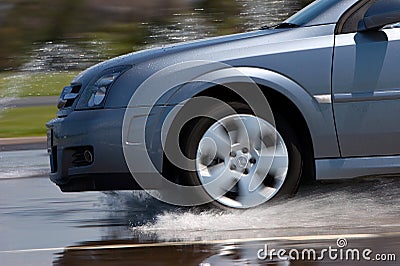 Modern Vehicle Driving on Wet Road Stock Photo