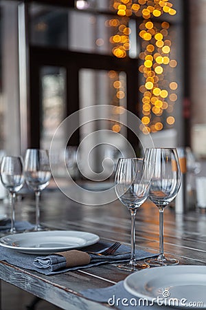 Modern veranda restaurant interior, banquet setting, glasses, plates Stock Photo