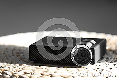 Modern video projector on wicker pouf indoors Stock Photo