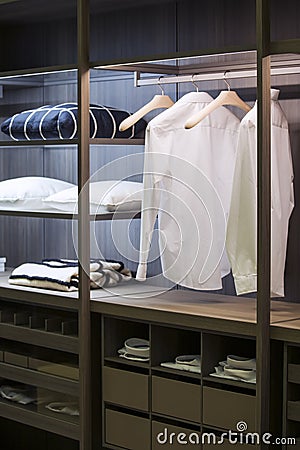 A modern wardrobe room with lighting, with examples of shelves for clothes in the apartment Stock Photo