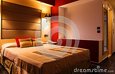 Modern, warm, inviting bedroom or hotel room. Light and shadows Stock Photo