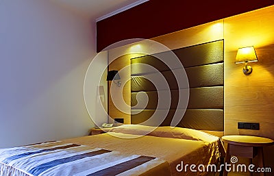 Modern, warm, inviting bedroom or hotel room. Light and shadows Stock Photo