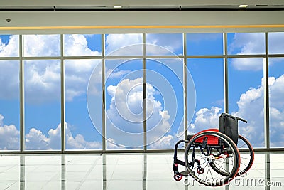 Modern wheelchair parked in empty room Stock Photo