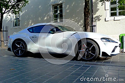 Modern white electric sports car in urban setting, Japanese made popular brand Stock Photo