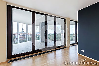 Modern white empty loft apartment interior with parquet floor with black column and panoramic windows, Overlooking the metropolis Stock Photo