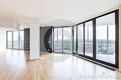 Modern white empty loft apartment interior with parquet floor and panoramic windows, Overlooking the metropolis city Stock Photo