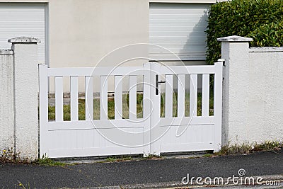 Modern white gate aluminum portal with blades of suburbs house Stock Photo