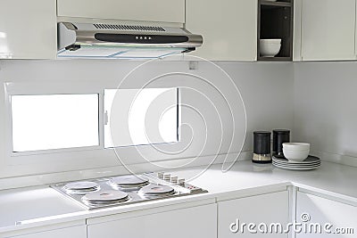 Modern white kitchen with counter and white details, minimalist interior Stock Photo