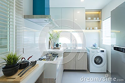 Modern white kitchen with counter and white details, minimalist interior Stock Photo