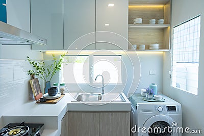 Modern white kitchen with counter and white details, minimalist interior Stock Photo