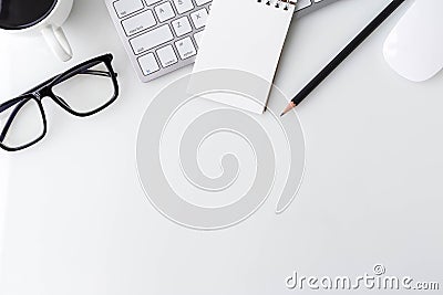 Modern white office desk top table with computer laptop, notebook and other supplies. Top view with copy space on white Stock Photo