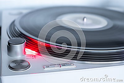 Modern white Turntable vinyl record player. Retro audio equipment for disc jockey. Sound technology for DJ to mix & play music. Stock Photo