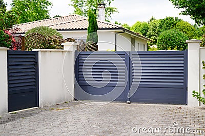 Modern wicket and grey gate of home aluminum portal suburb door in house Stock Photo