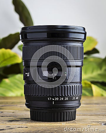 Modern wide angle DSLR lens on a wooden table Stock Photo