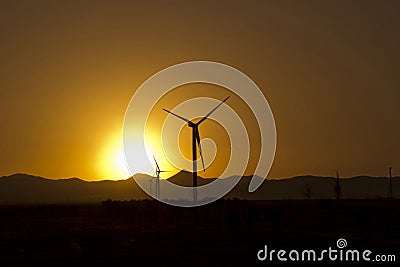 Modern Windmill Turbine or Wind Power in sunset Stock Photo