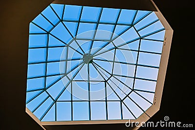 Modern window in the roof of the building, designed for natural light and ventilation. Sky through the glass window at the top of Stock Photo