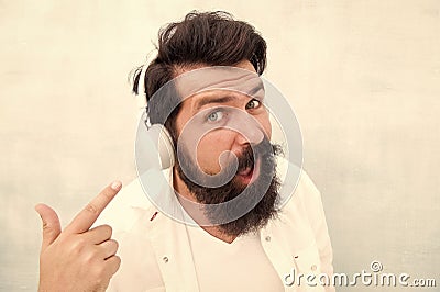 Modern wireless headphones. Electronic dance music tracks. Instrumental music. Bearded man headphones. Enjoy every note Stock Photo