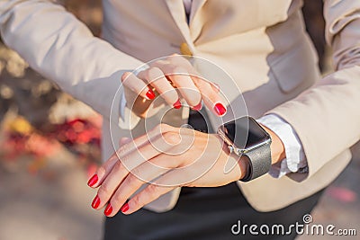 Modern woman checking time on her smartwatch Stock Photo