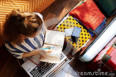 Modern woman at modern home in sunny summer day planning trip Stock Photo