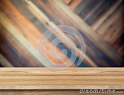 modern wooden table top at blurred diagonal wood plank wall,Template mock up for display or montage of product. Stock Photo