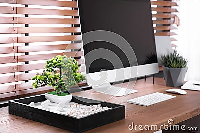 Modern workplace with beautiful miniature zen garden and computer Stock Photo
