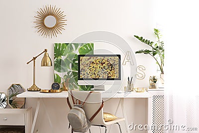 Modern workplace with computer and golden decor on desk. Stylish interior design Stock Photo