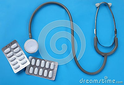 Close up Stethoscope and pill isolate on blue background .Copy space Medical and health concept Stock Photo