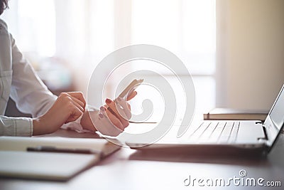 Modern workplace woman using mobile phone in office. Stock Photo