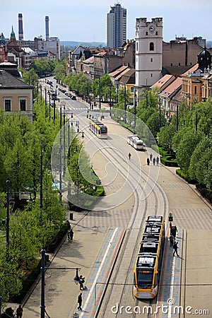 Modern yellow trams in Debrecen, Hungary, in a sunny spring day Stock Photo