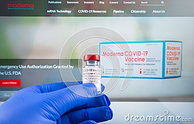 Moderna logo and covid19 corona vaccine vial beeing hold by doctor Editorial Stock Photo